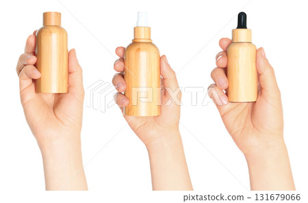 Set of human hand holding bamboo cosmetic bottle isolated on transparent background 131679066