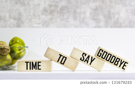 Time to say goodbye is a word written on wooden blocks. Time to say goodbye - text on the table Time to say goodbye is a word written on wooden blocks. Time to say goodbye - text on the table 131679283