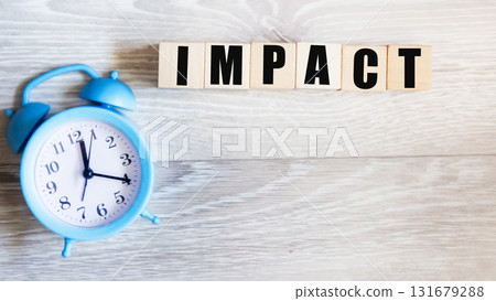 IMPACT ,a word on wooden blocks on a gray background 131679288