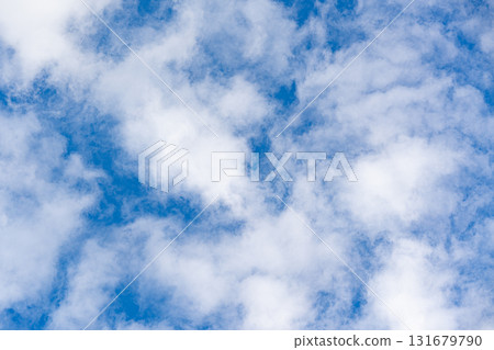 Soft textured white clouds across vibrant blue sky, airy weather background with copy space for nature, freedom, travel, and optimism themes, minimal and serene. Soft textured white clouds across vibrant blue sky, airy weather background with copy space for nature, freedom, travel, and optimism themes, minimal and serene. 131679790