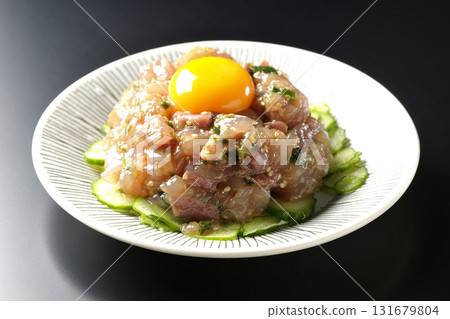 Spanish mackerel tartare photographed against a black background Spanish mackerel tartare photographed against a black background 131679804