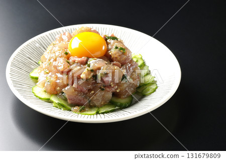Spanish mackerel tartare photographed against a black background 131679809
