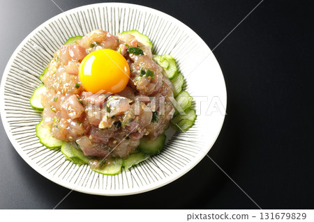 Spanish mackerel tartare photographed against a black background Spanish mackerel tartare photographed against a black background 131679829
