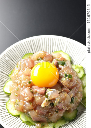 Spanish mackerel tartare photographed against a black background Spanish mackerel tartare photographed against a black background 131679843