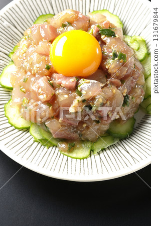 Spanish mackerel tartare photographed against a black background Spanish mackerel tartare photographed against a black background 131679844