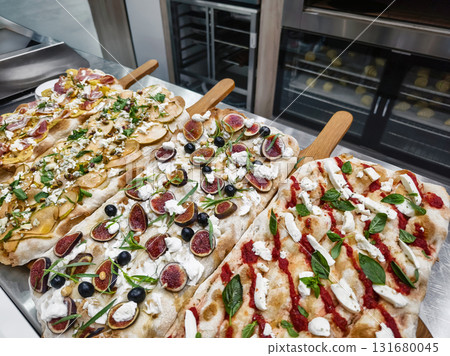 pizzas topped with fresh ingredients served at a modern eatery in the afternoon pizzas topped with fresh ingredients served at a modern eatery in the afternoon 131680045