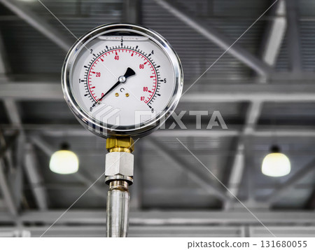 Pressure gauge measures force in industrial setting showcasing equipment functionality and design clarity Pressure gauge measures force in industrial setting showcasing equipment functionality and design clarity 131680055
