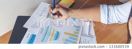 Banner Businesswoman reading financial graph charts business info with computer laptop. Panorama Women hands using laptop on office desk. Hands of business woman working office with copy space 131680539