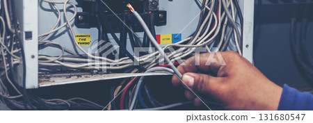 Banner Electrical mechanic technician check wire electric cabinet. Inspector men hands working maintenance service. Electrician circuit repair operation. Men hands fix breaker with copy space Banner Electrical mechanic technician check wire electric cabinet. Inspector men hands working maintenance service. Electrician circuit repair operation. Men hands fix breaker with copy space 131680547