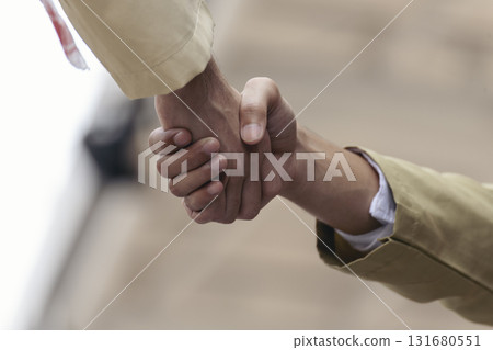 Arab Businessman shaking hands together. Teamwork business partner wear Muslim dress Shake Hands with Partnership Concept. Success UAE diversity people trust make commitment by handshake Arab Businessman shaking hands together. Teamwork business partner wear Muslim dress Shake Hands with Partnership Concept. Success UAE diversity people trust make commitment by handshake 131680551
