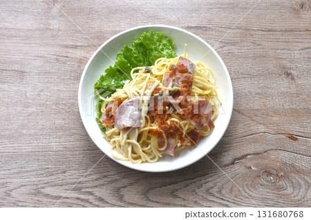 fried spaghetti white cabonara cream sauce topping slice crispy pork bacon and lettuce on plate  131680768