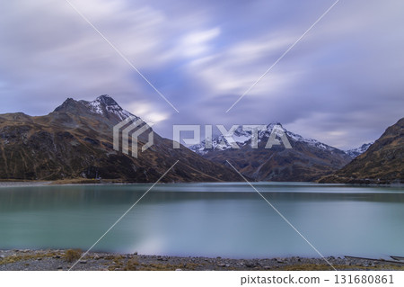 Alpine mountains reflecting on Silvretta lake in Vorarlberg Austria Alpine mountains reflecting on Silvretta lake in Vorarlberg Austria 131680861
