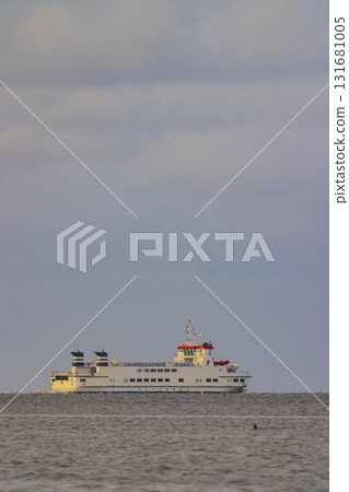 Ferry navigating calm water on cloudy day 131681005