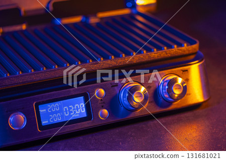 Modern electric grill displaying cooking temperature and time 131681021