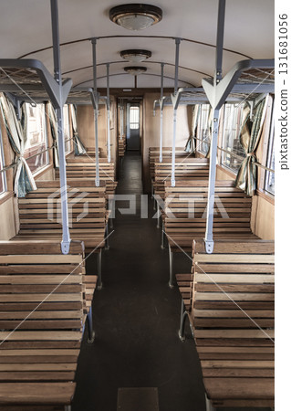 Vintage train carriage empty interior with wooden benches 131681056