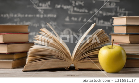 book resting on stacked in front of a chalkboard book resting on stacked in front of a chalkboard 131681117