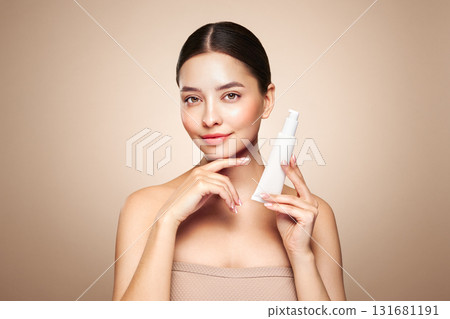 Beautiful woman with bottle of moisturizer cream 131681191