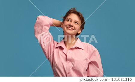 Smiling woman touching head with dreamy thoughtful expression Smiling woman touching head with dreamy thoughtful expression 131681310