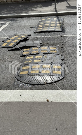 Damaged speed bumps on urban road with sunlight creating textures Damaged speed bumps on urban road with sunlight creating textures 131681327