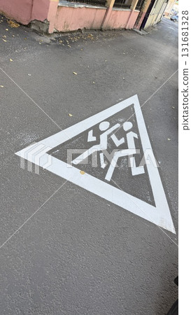 Pedestrian crossing sign painted on urban street pavement conveying safety message 131681328