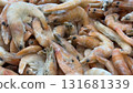 Frozen shrimps piled closely, showcasing seafood texture and detail for culinary backgrounds 131681339