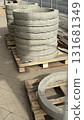 Concrete rings stacked on wooden pallets at construction site in outdoor setting 131681349