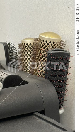 Hairbrushes organized in a holder, featuring various brush types, suitable for hairstyling background Hairbrushes organized in a holder, featuring various brush types, suitable for hairstyling background 131681350
