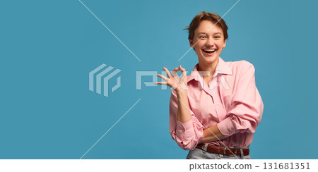 Smiling woman showing ok hand gesture expressing confidence and positivity Smiling woman showing ok hand gesture expressing confidence and positivity 131681351