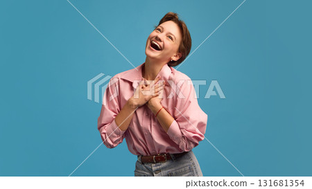 Happy young woman with hands on chest expressing gratitude and joy Happy young woman with hands on chest expressing gratitude and joy 131681354