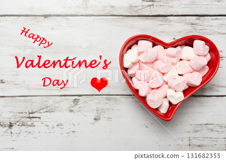 A bright red heart-shaped cocotte dish and heart-shaped marshmallows 131682355