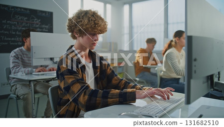 Student in Checkered Shirt Doing Examination Project on Game Development Student in Checkered Shirt Doing Examination Project on Game Development 131682510