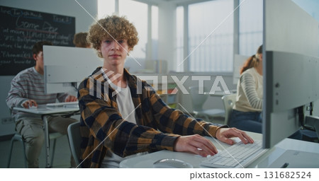 Curly Haired Young Man Working on Game Development Project Curly Haired Young Man Working on Game Development Project 131682524