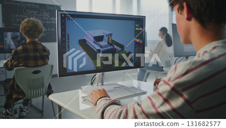 Student in Striped Sweatshirt Works on 3D House Project at Computer Screen 131682577
