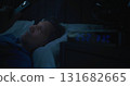 Mature Man in Bed Illuminated By Smartphone Screen, Digital Clock Showing Two AM 131682665