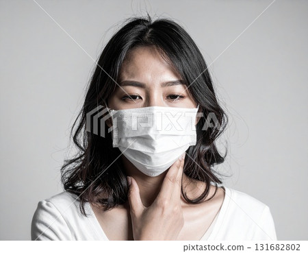 A woman wearing a mask because she has a cold and coughs A woman wearing a mask because she has a cold and coughs 131682802