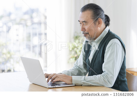 Senior man working on a laptop Senior man working on a laptop 131682806