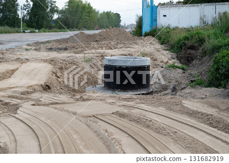 Construction site showing wastewater management system installation in a sandy trench Construction site showing wastewater management system installation in a sandy trench 131682919