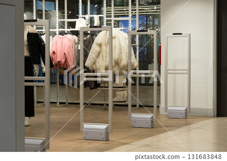 Radio-frequency security gates with integrated metal detector at a clothing store entrance 131683848