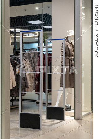 Radio-frequency security gates with integrated metal detector at a clothing store entrance 131683849