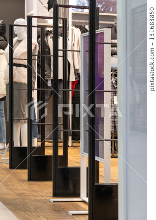 Radio-frequency security gates with integrated metal detector at a clothing store entrance 131683850