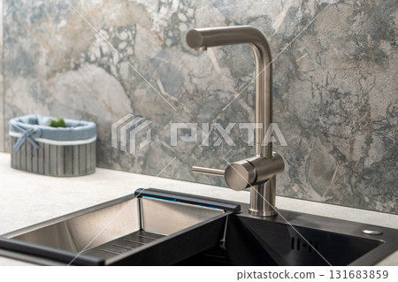 A stainless steel kitchen faucet 131683859