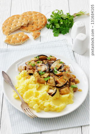 Fried porcini mushrooms with potato mash on plate 131684105