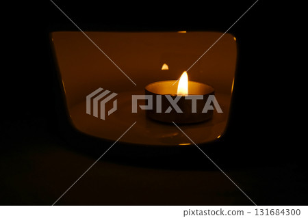 Close-up of the candle. Lighting concept. Abstract background. Close-up of the candle. Lighting concept. Abstract background. 131684300