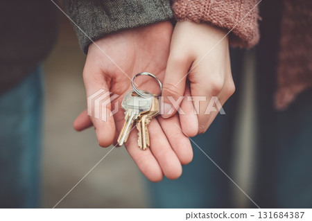 Ai generated Hands holding house keys with small home keychain 131684387