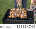 Happy family preparing barbecue in the garden together outdoor 131684744