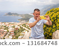 Tourist man caking photos of city of Kas in Turkey from a panoramic viewpoint 131684748