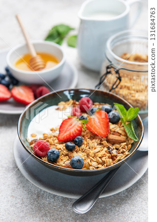 Healthy breakfast bowl with granola, yogurt, and berries Healthy breakfast bowl with granola, yogurt, and berries 131684763