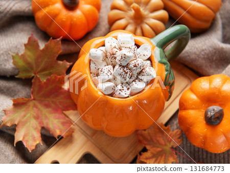 Cozy pumpkin mug with hot chocolate and marshmallows 131684773