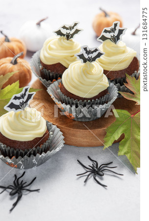 Halloween cupcakes with bats, pumpkins, and autumn leaves Halloween cupcakes with bats, pumpkins, and autumn leaves 131684775