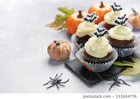 Halloween cupcakes with bat toppers and pumpkin decorations Halloween cupcakes with bat toppers and pumpkin decorations 131684776
